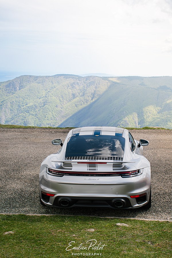 Porsche 911 Turbo S argentée face à la montagne